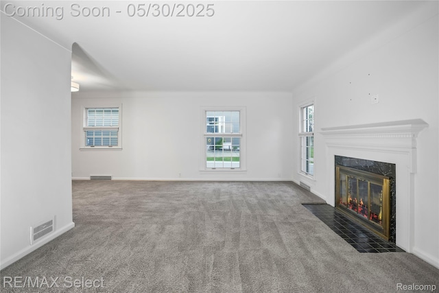 2302 Radcliffe Ave, Flint, MI 48503 - unfurnished living room featuring carpet, a high end fireplace, and baseboards