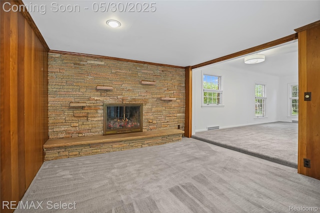 2302 Radcliffe Ave, Flint, MI 48503 - unfurnished living room featuring carpet floors, a fireplace, ornamental molding, and baseboards
