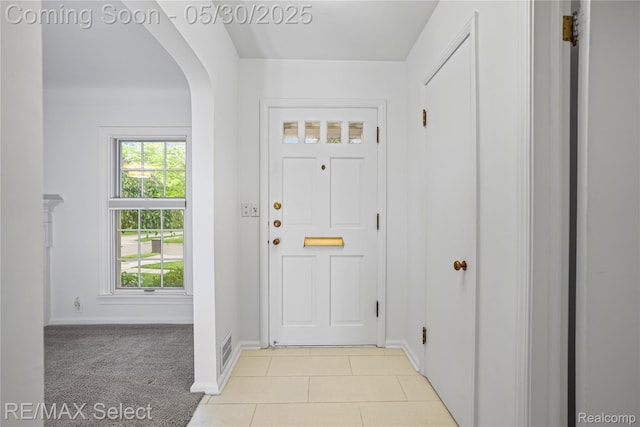 2302 Radcliffe Ave, Flint, MI 48503 - entrance foyer featuring arched walkways, baseboards, and light tile patterned floors