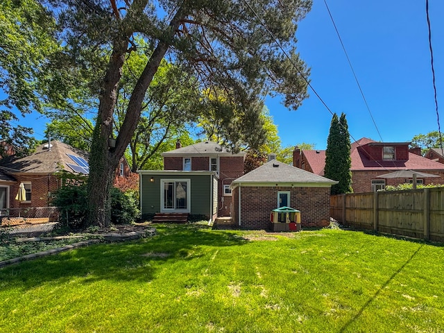 rear view of house with brick siding and entry steps