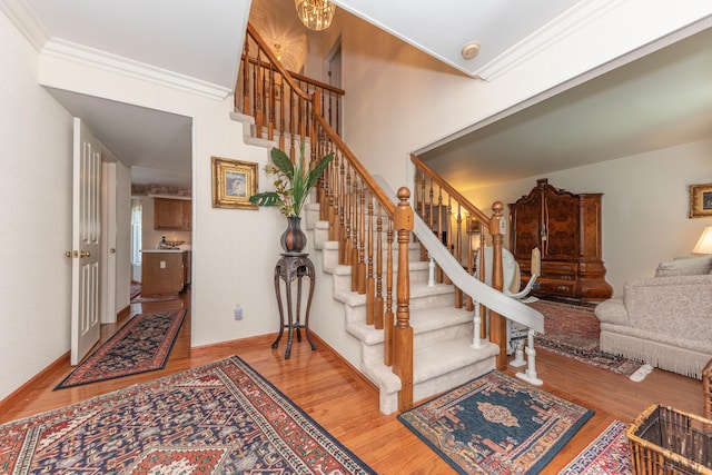 5835 S Ashford Way, Ypsilanti, MI 48197 - stairway featuring wood finished floors, crown molding, and baseboards