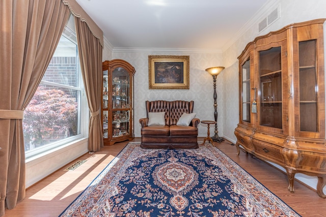 5835 S Ashford Way, Ypsilanti, MI 48197 - living area with plenty of natural light, wood finished floors, ornamental molding, baseboards, and wallpapered walls