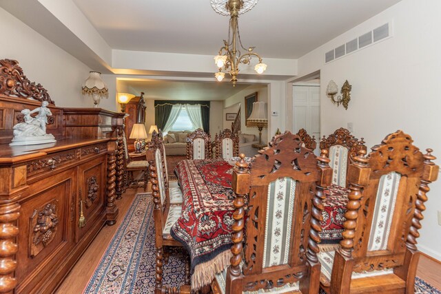 5835 S Ashford Way, Ypsilanti, MI 48197 - dining space with light wood finished floors and a chandelier