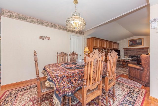 5835 S Ashford Way, Ypsilanti, MI 48197 - dining space with a chandelier, light wood-style floors, and vaulted ceiling