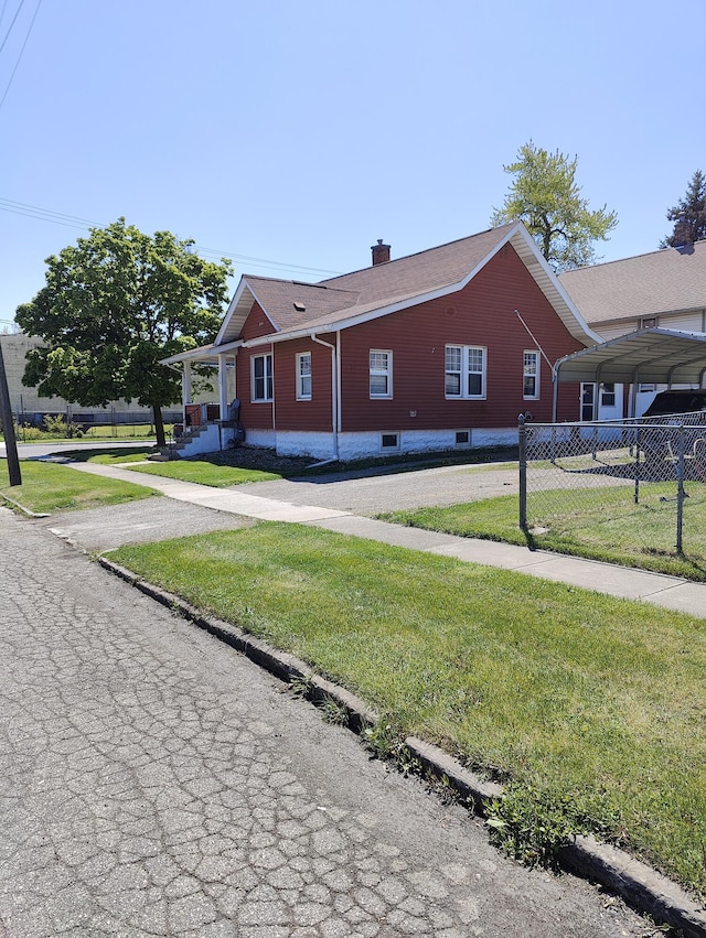 view of side of property featuring asphalt driveway and a chimney