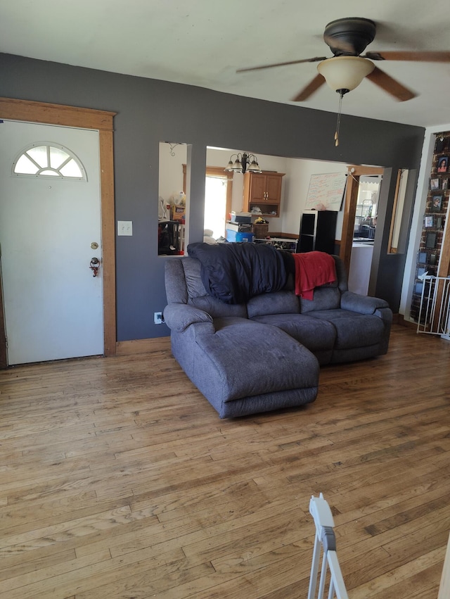 living area featuring a ceiling fan and light wood-style floors