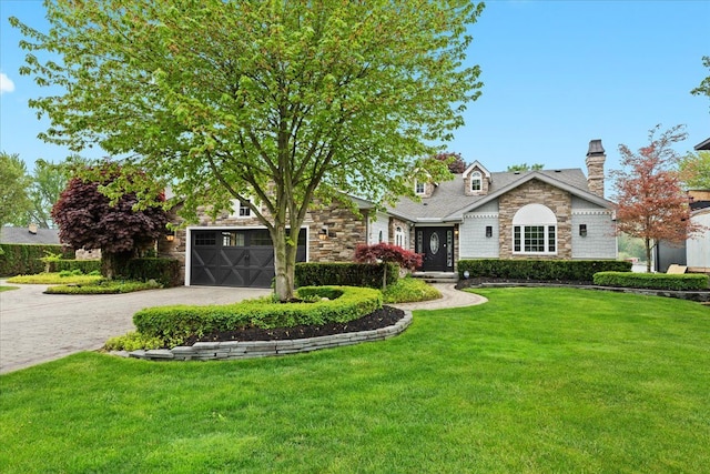 3767 Carrie Ln, Walled Lake, MI 48390 - view of front facade with stone siding, driveway, a front lawn, and a chimney