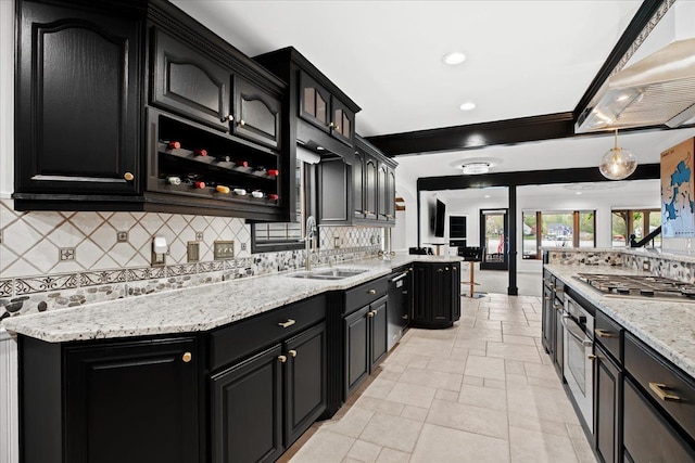 3767 Carrie Ln, Walled Lake, MI 48390 - kitchen featuring appliances with stainless steel finishes, dark cabinets, wall chimney exhaust hood, a sink, and decorative backsplash