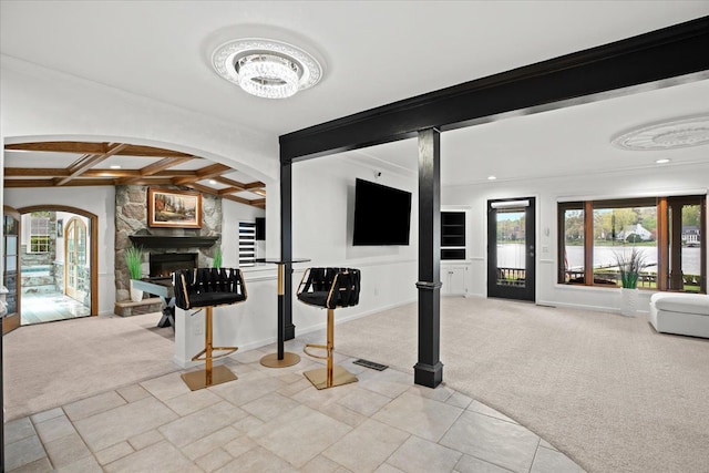 3767 Carrie Ln, Walled Lake, MI 48390 - interior space featuring carpet flooring, arched walkways, a stone fireplace, coffered ceiling, and baseboards