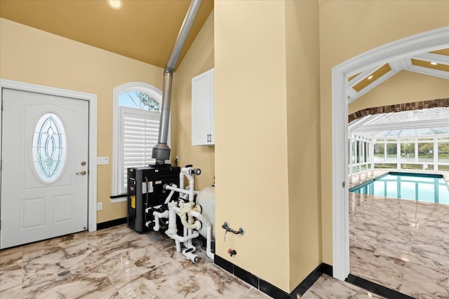3767 Carrie Ln, Walled Lake, MI 48390 - foyer entrance featuring vaulted ceiling, light marble finish flooring, and baseboards