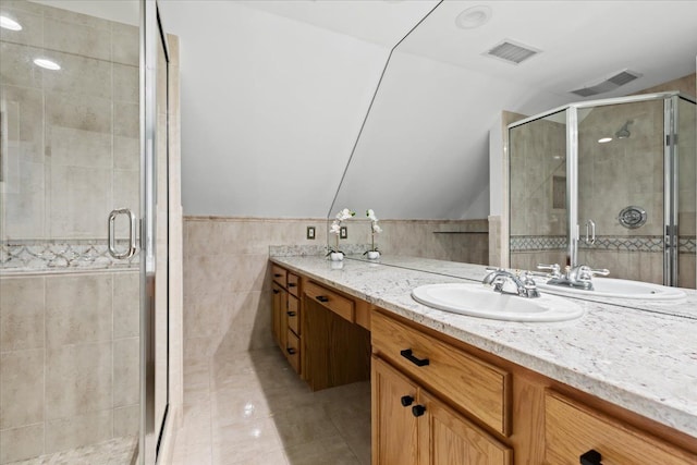 3767 Carrie Ln, Walled Lake, MI 48390 - full bathroom featuring tile walls, tile patterned flooring, vanity, a shower stall, and lofted ceiling