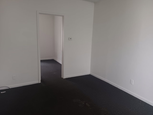 1517 Tacoma St, Flint, MI 48503 - spare room featuring dark colored carpet and baseboards