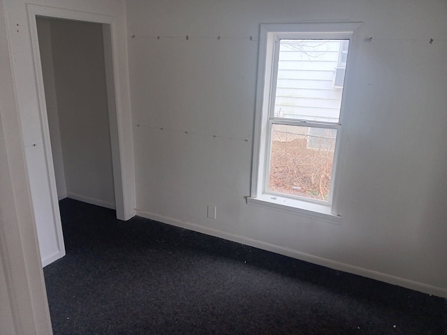 1517 Tacoma St, Flint, MI 48503 - spare room with baseboards, healthy amount of natural light, and dark colored carpet