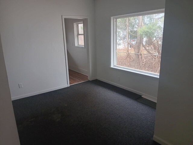 1517 Tacoma St, Flint, MI 48503 - spare room with dark carpet and baseboards