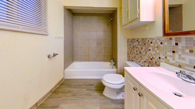 11376 Rivard Ave, Warren, MI 48089 - bathroom featuring toilet, bathing tub / shower combination, wood finished floors, vanity, and baseboards