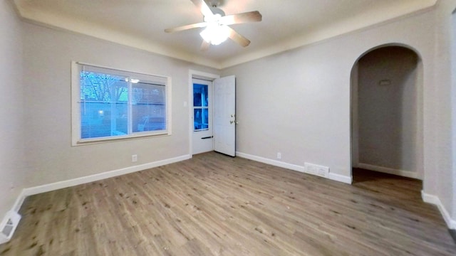 11376 Rivard Ave, Warren, MI 48089 - unfurnished room with arched walkways, wood finished floors, ceiling fan, and baseboards
