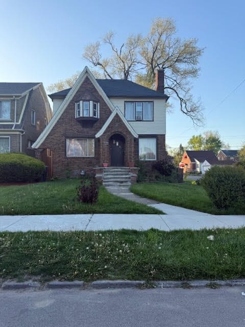 11101 College St, Detroit, MI 48205 - tudor house with a chimney and a front yard