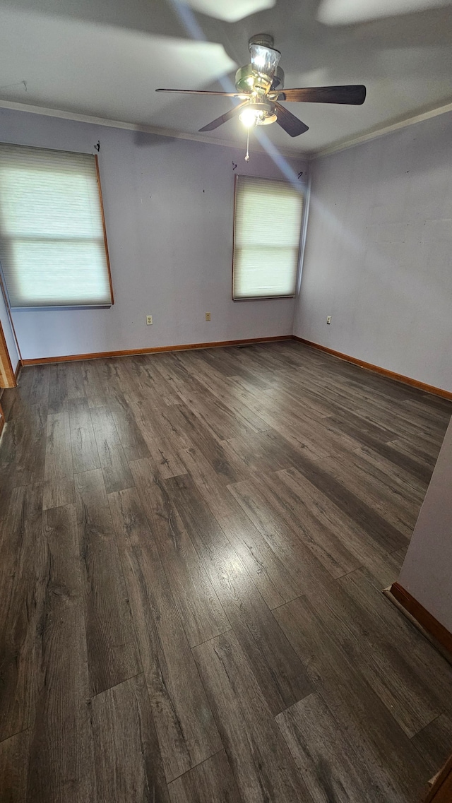 empty room with wood-type flooring, ceiling fan, and baseboards