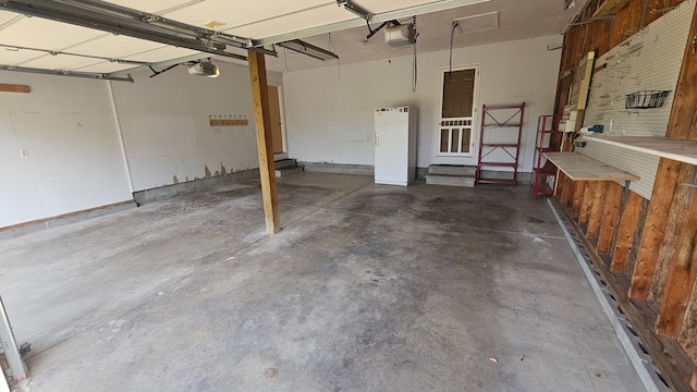 garage featuring a garage door opener and a workshop area