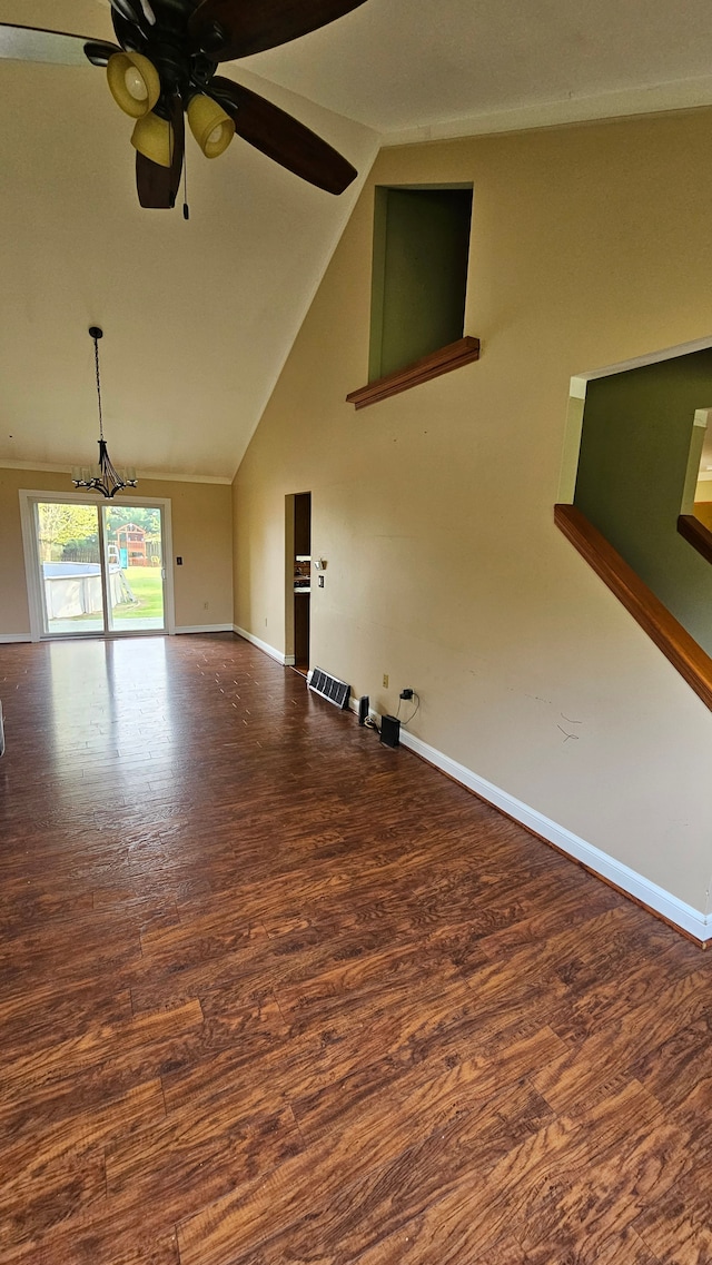 unfurnished living room featuring baseboards, ceiling fan, wood finished floors, a chandelier, and high vaulted ceiling