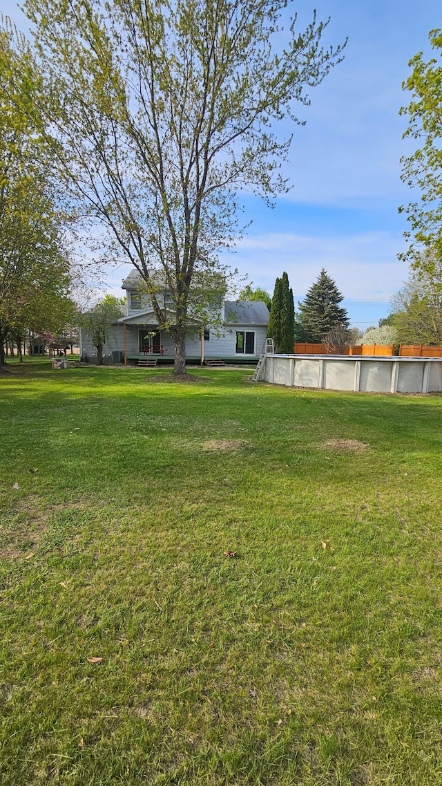 view of grassy yard featuring an outdoor pool
