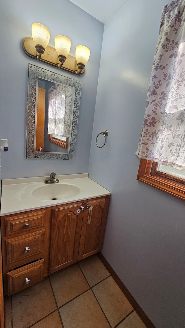 bathroom featuring tile patterned floors, vanity, and baseboards