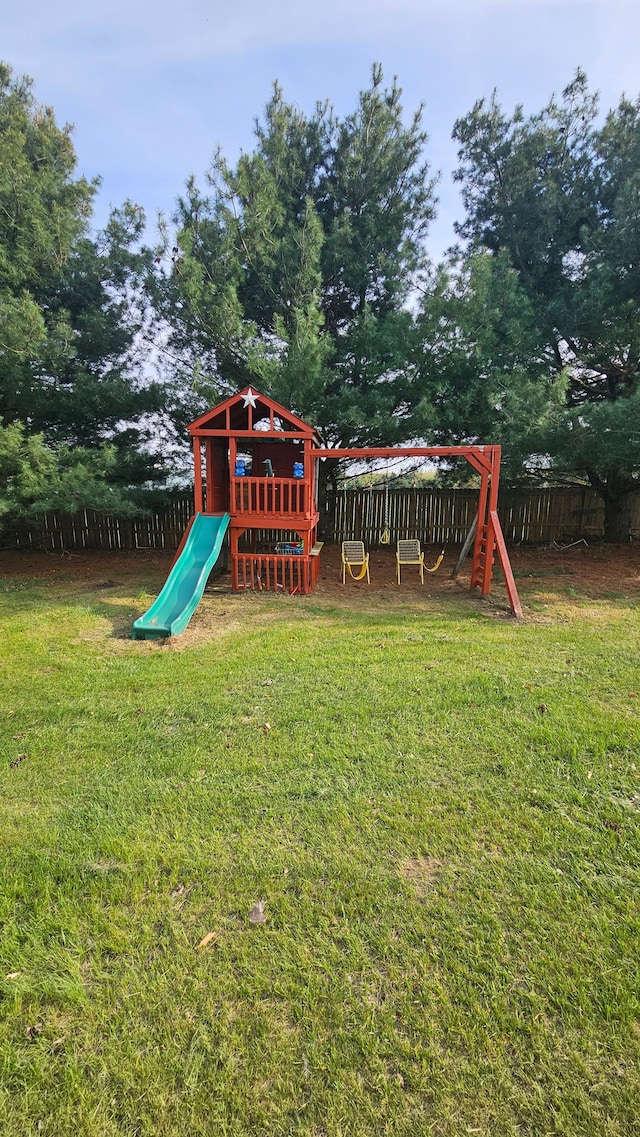 view of playground featuring view of wooded area