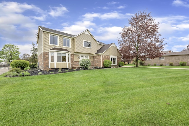 744 Lockmoore Ct, Rochester Hills, MI 48307 - view of front of house with brick siding and a front yard