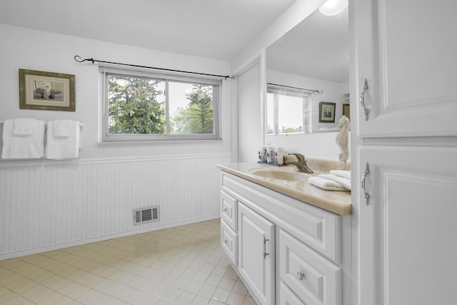 744 Lockmoore Ct, Rochester Hills, MI 48307 - bathroom with wainscoting, plenty of natural light, vanity, and tile patterned floors