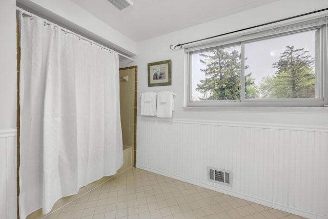 744 Lockmoore Ct, Rochester Hills, MI 48307 - bathroom featuring wainscoting, shower / bath combination with curtain, and tile patterned flooring