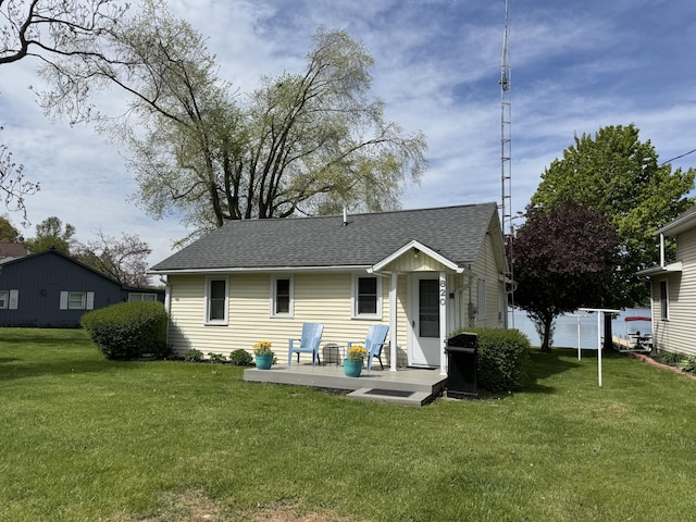 820 N Werners Landing Dr, Bronson, MI 49028 - back of property with a shingled roof and a patio