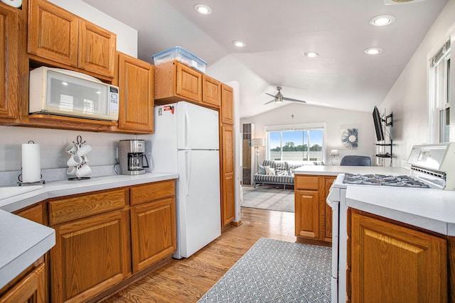 820 N Werners Landing Dr, Bronson, MI 49028 - kitchen featuring white appliances, lofted ceiling, a ceiling fan, light wood-style flooring, and open floor plan