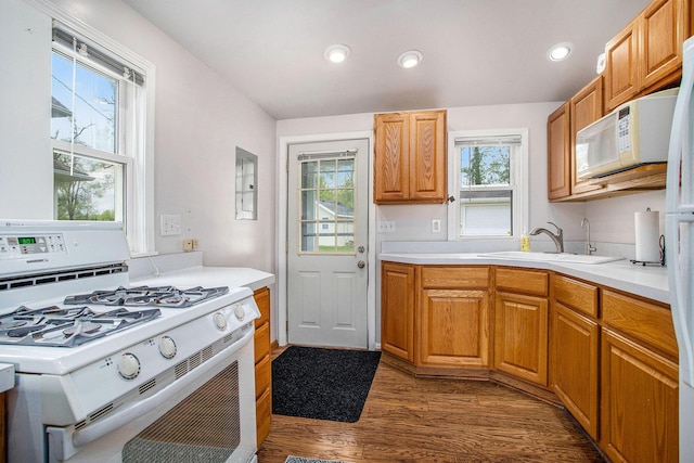 820 N Werners Landing Dr, Bronson, MI 49028 - kitchen with white appliances, dark wood-style floors, light countertops, a sink, and recessed lighting