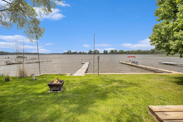 820 N Werners Landing Dr, Bronson, MI 49028 - view of grassy yard with a boat dock, an outdoor fire pit, and a water view