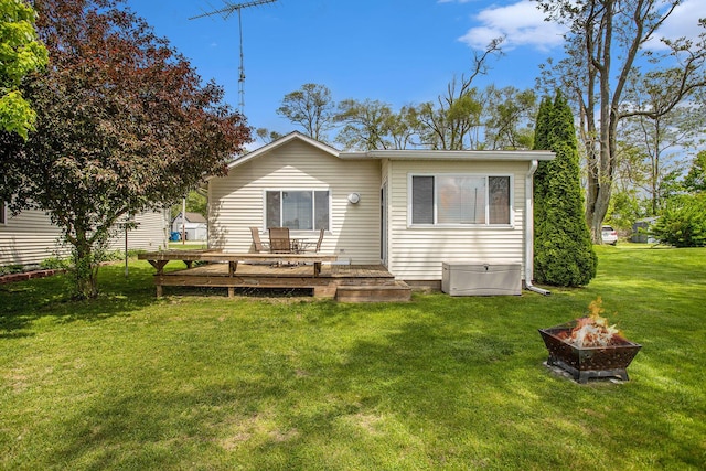 820 N Werners Landing Dr, Bronson, MI 49028 - back of property featuring a fire pit, a deck, and a yard