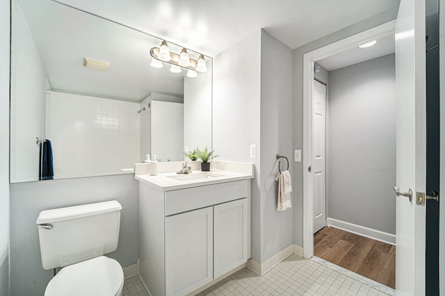 3320 Spinnaker Ln Unit 13B, Detroit, MI 48207 - bathroom featuring toilet, tile patterned flooring, vanity, baseboards, and a shower