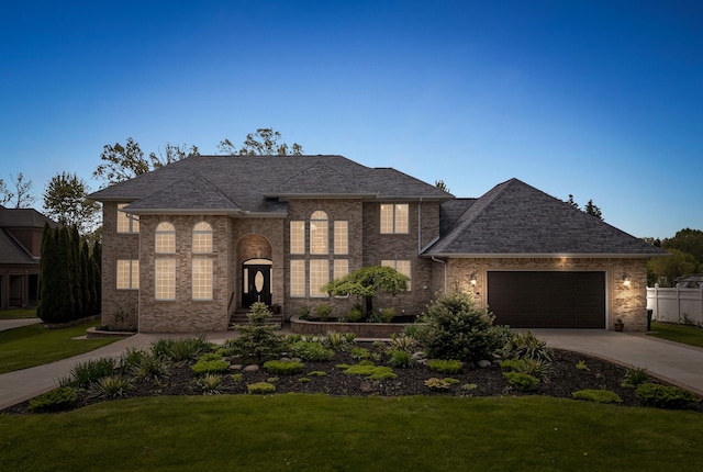 1334 Larayne Dr, Troy, MI 48085 - view of front of house featuring concrete driveway, a front lawn, a garage, brick siding, and roof with shingles