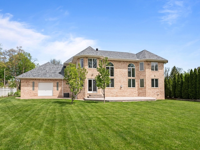 1334 Larayne Dr, Troy, MI 48085 - back of house with a lawn, an attached garage, brick siding, entry steps, and roof with shingles