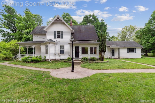 101 Hill St, Stockbridge, MI 49285 - victorian house featuring a front lawn, a chimney, and a porch