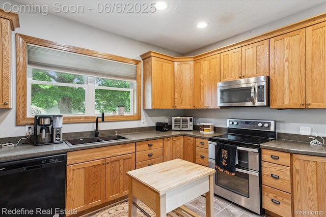 101 Hill St, Stockbridge, MI 49285 - kitchen with stainless steel appliances, a sink, dark countertops, recessed lighting, and light tile patterned floors