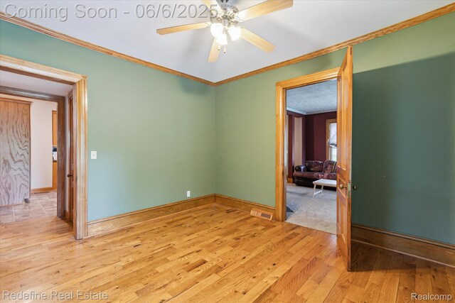 101 Hill St, Stockbridge, MI 49285 - empty room featuring light wood-type flooring, ornamental molding, a ceiling fan, and baseboards