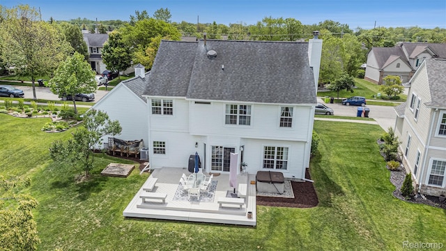 1122 Colt Dr, South Lyon, MI 48178 - back of property featuring a wooden deck, a chimney, a yard, and a residential view