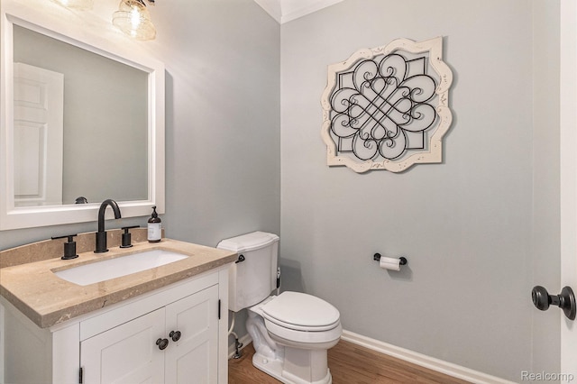 1122 Colt Dr, South Lyon, MI 48178 - half bath featuring vanity, toilet, baseboards, and wood finished floors