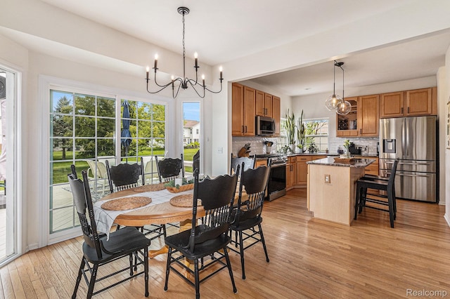1122 Colt Dr, South Lyon, MI 48178 - dining room with a chandelier and light wood-style flooring
