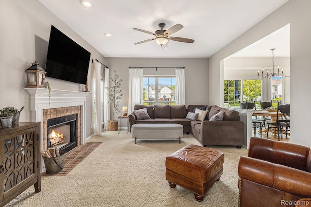 1122 Colt Dr, South Lyon, MI 48178 - carpeted living area featuring a ceiling fan, a fireplace, a chandelier, and recessed lighting