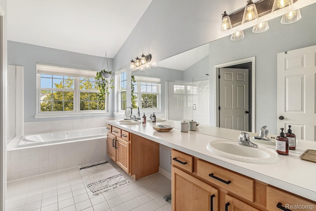 1122 Colt Dr, South Lyon, MI 48178 - full bath featuring tile patterned flooring, double vanity, plenty of natural light, a garden tub, and lofted ceiling
