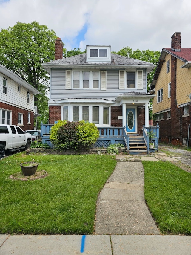 2036 Collingwood St, Detroit, MI 48206 - american foursquare style home featuring a front yard, brick siding, and a chimney