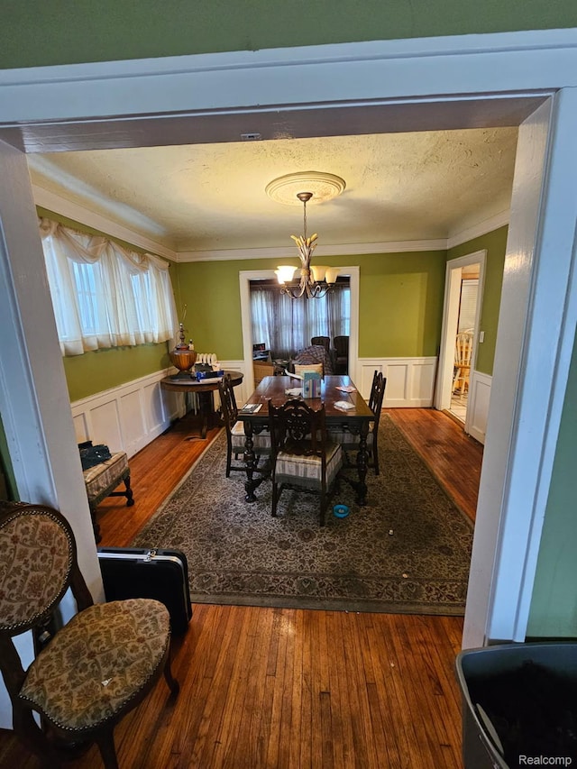 2036 Collingwood St, Detroit, MI 48206 - dining room featuring a chandelier, crown molding, wainscoting, wood-type flooring, and a decorative wall