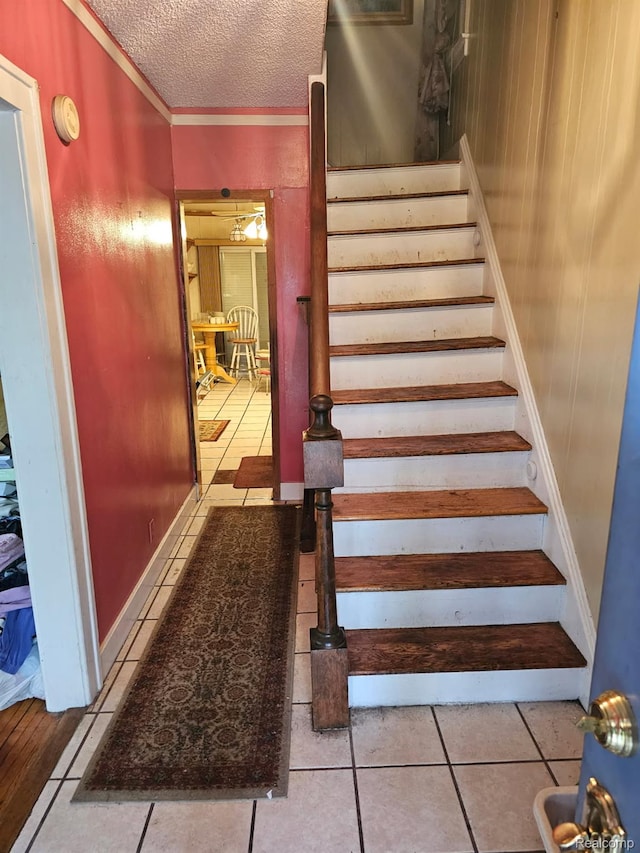 2036 Collingwood St, Detroit, MI 48206 - stairway with tile patterned flooring, a textured ceiling, and baseboards
