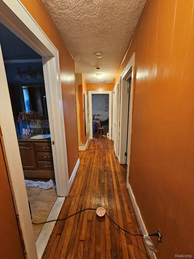 2036 Collingwood St, Detroit, MI 48206 - corridor featuring hardwood / wood-style floors, a textured ceiling, and a sink